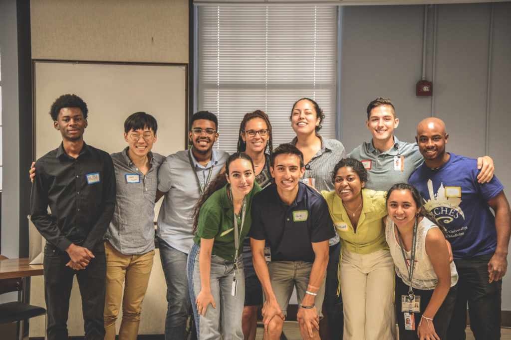 Students in the ARCHES program stand together indoors on campus