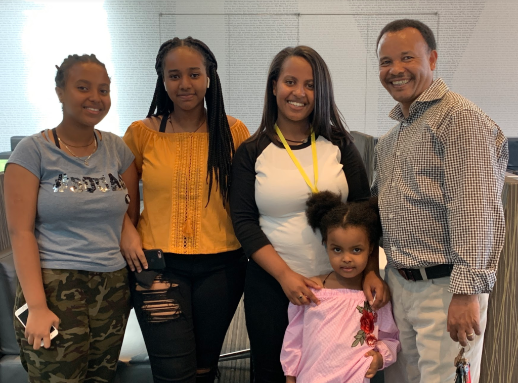 A student and family stand together