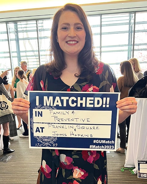 Ruth Watson holds a sign that reads I Matched!! In Family & Preventive at Franklin Square and Johns Hopkins