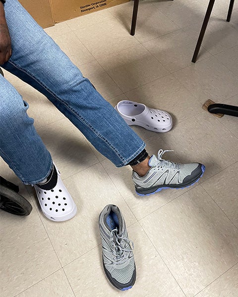 A person shows off their new pair of shoes