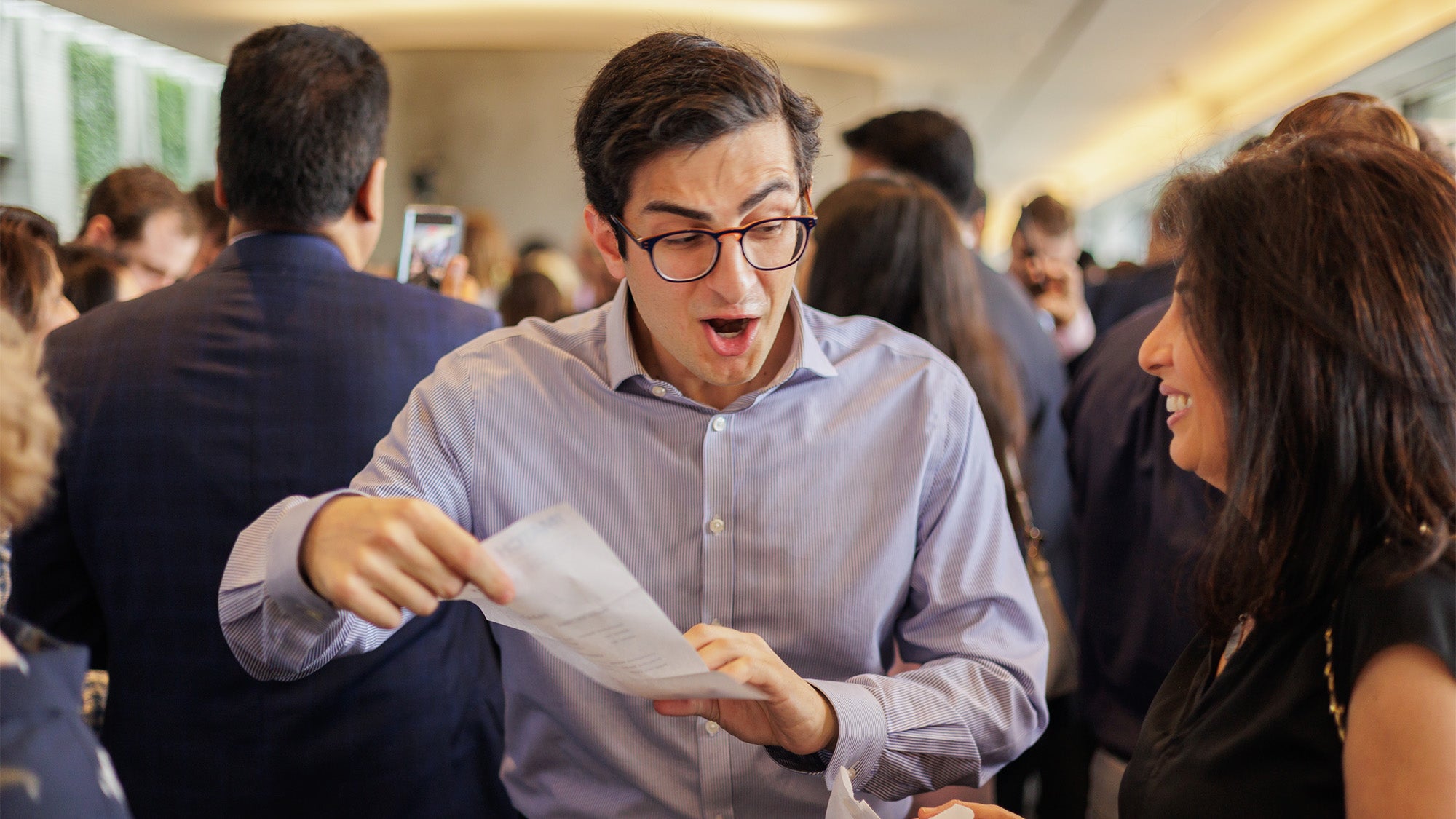 A medical student reacts with surprise at his match