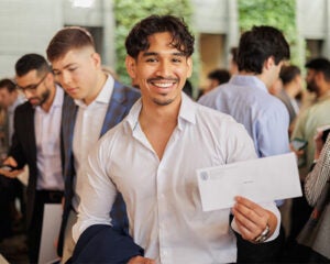 A student holds his Match Day envelope