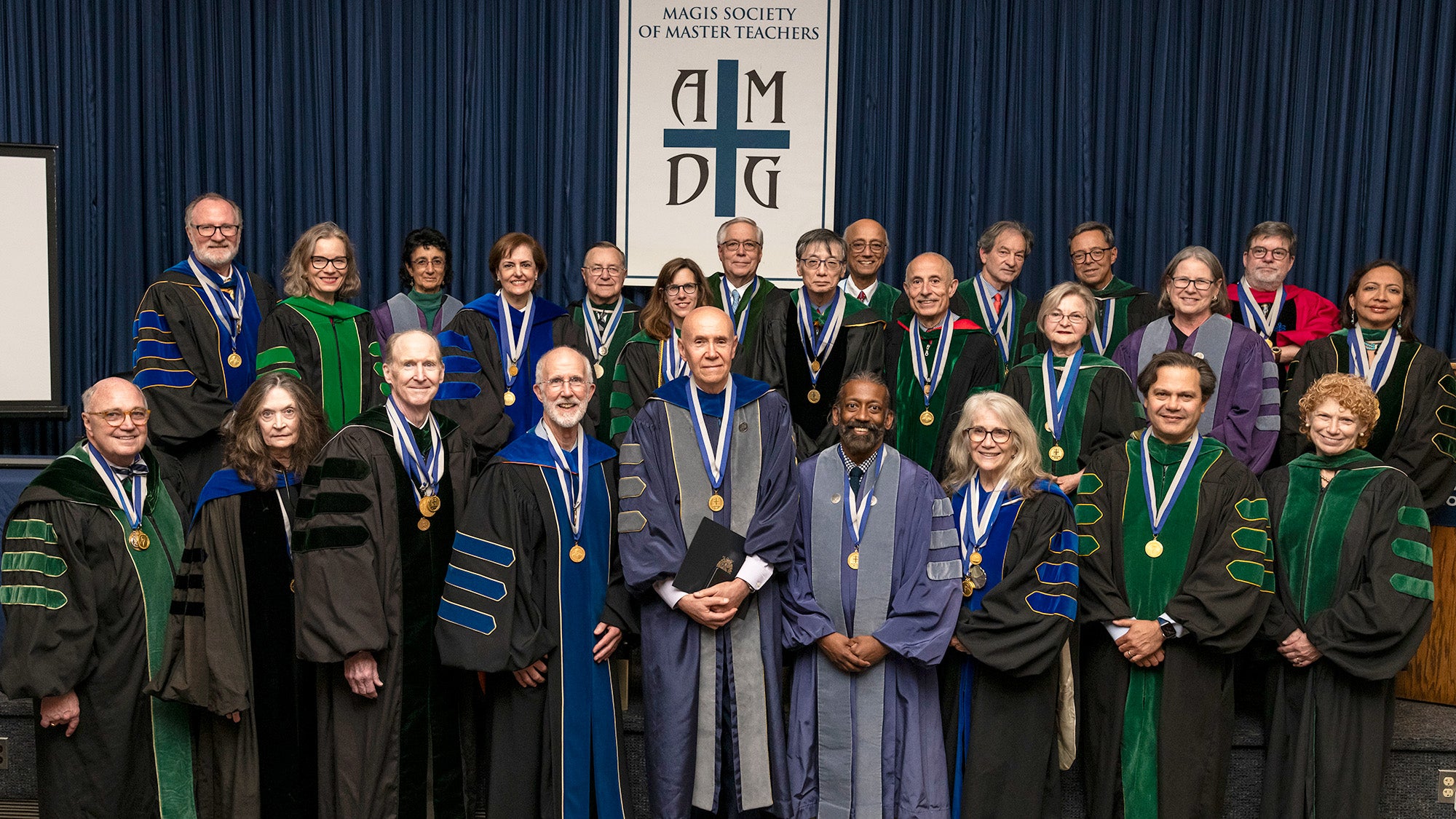 The MAGIS awardees stand together as a group dressed in academic regalia
