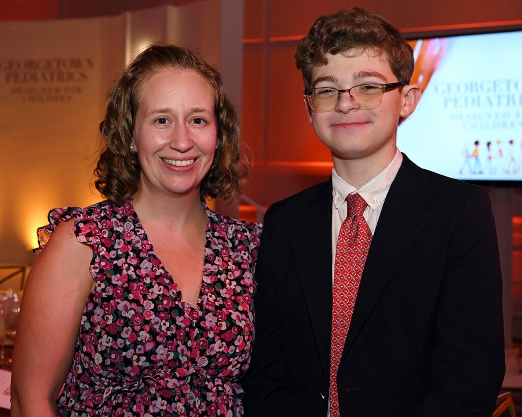 Katie Wallace and Jim stand side by side at the gala