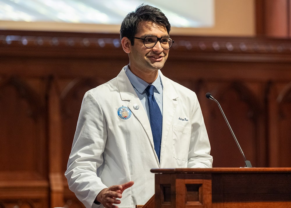 Adi Rao speaks from a podium in Dahlgren Chapel