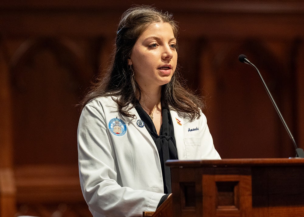 Amanda Hamze speaks from a podium in Dahlgren Chapel
