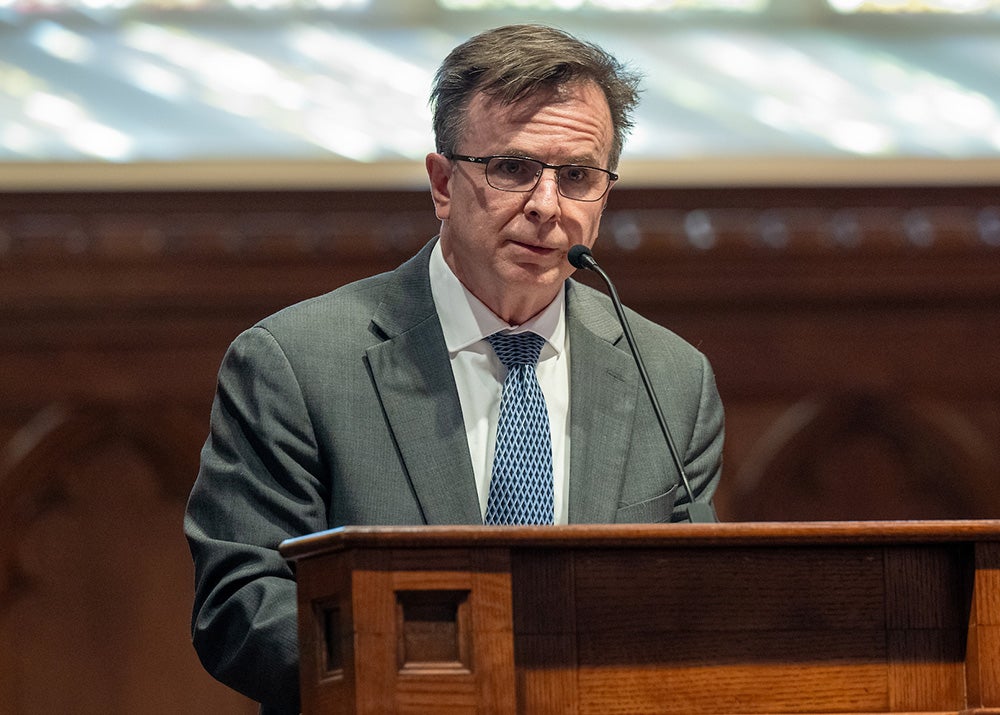 Norman Beauchamp speaks from a podium