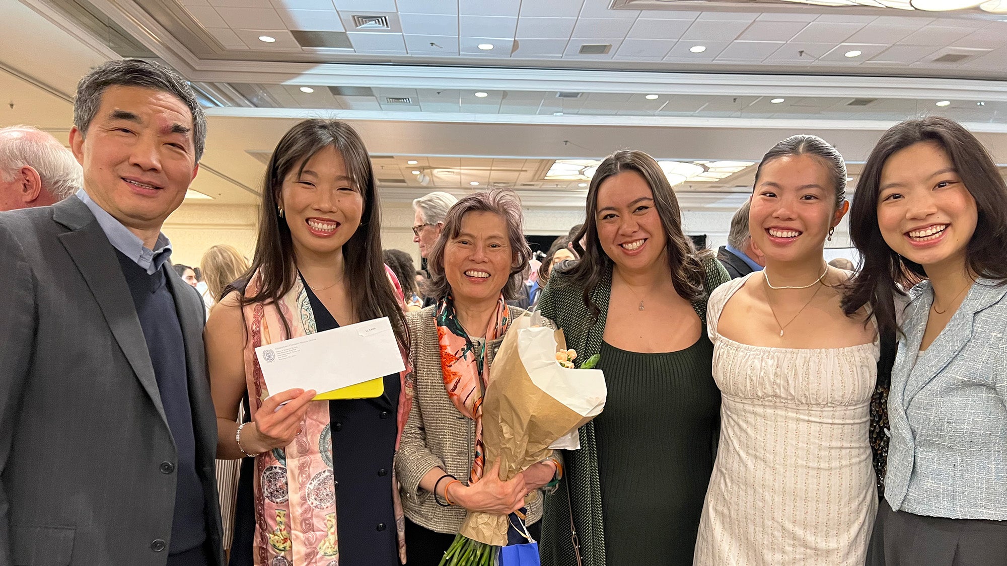 The Li family stands together with Karen Li who is holding her match envelope