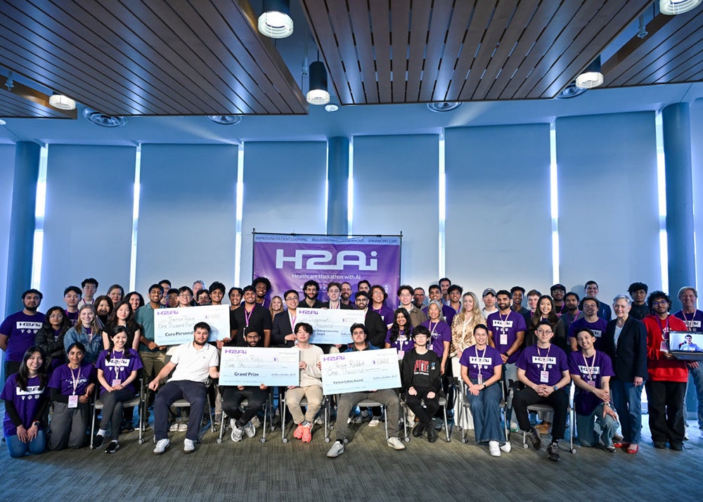 All Hackathon participants and organizers stand together in a large group