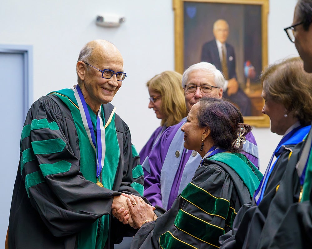 Wolfgang Rennert shakes hands with MAGIS members
