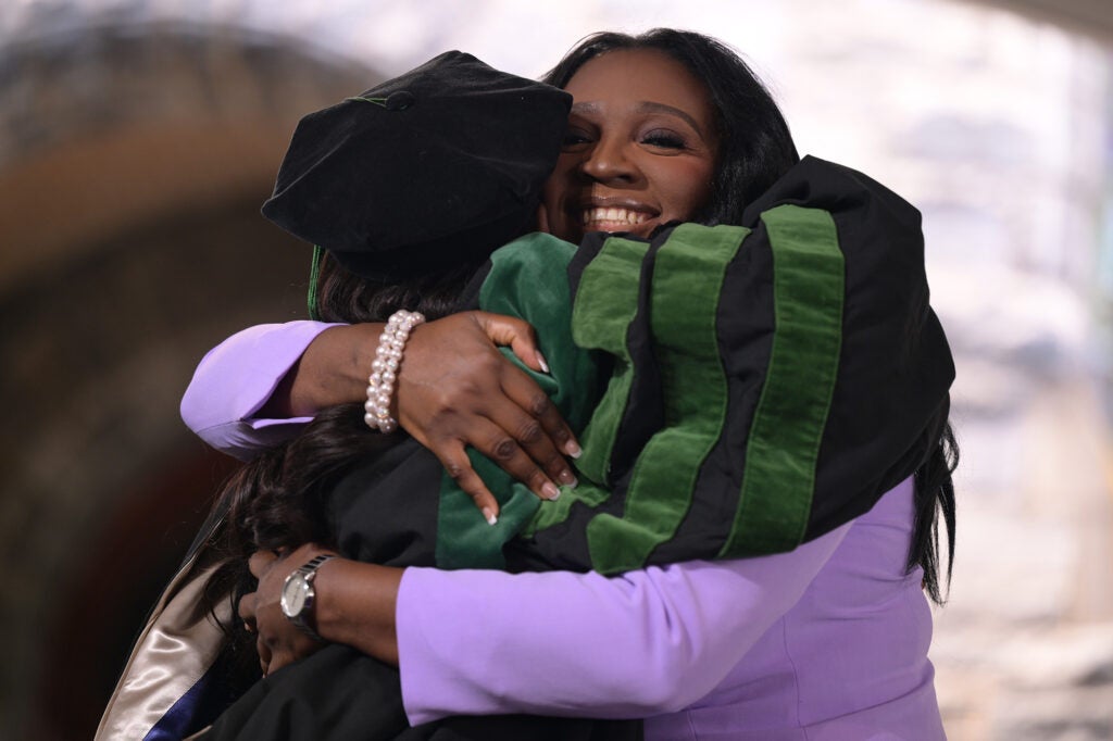 A parent hugs her student