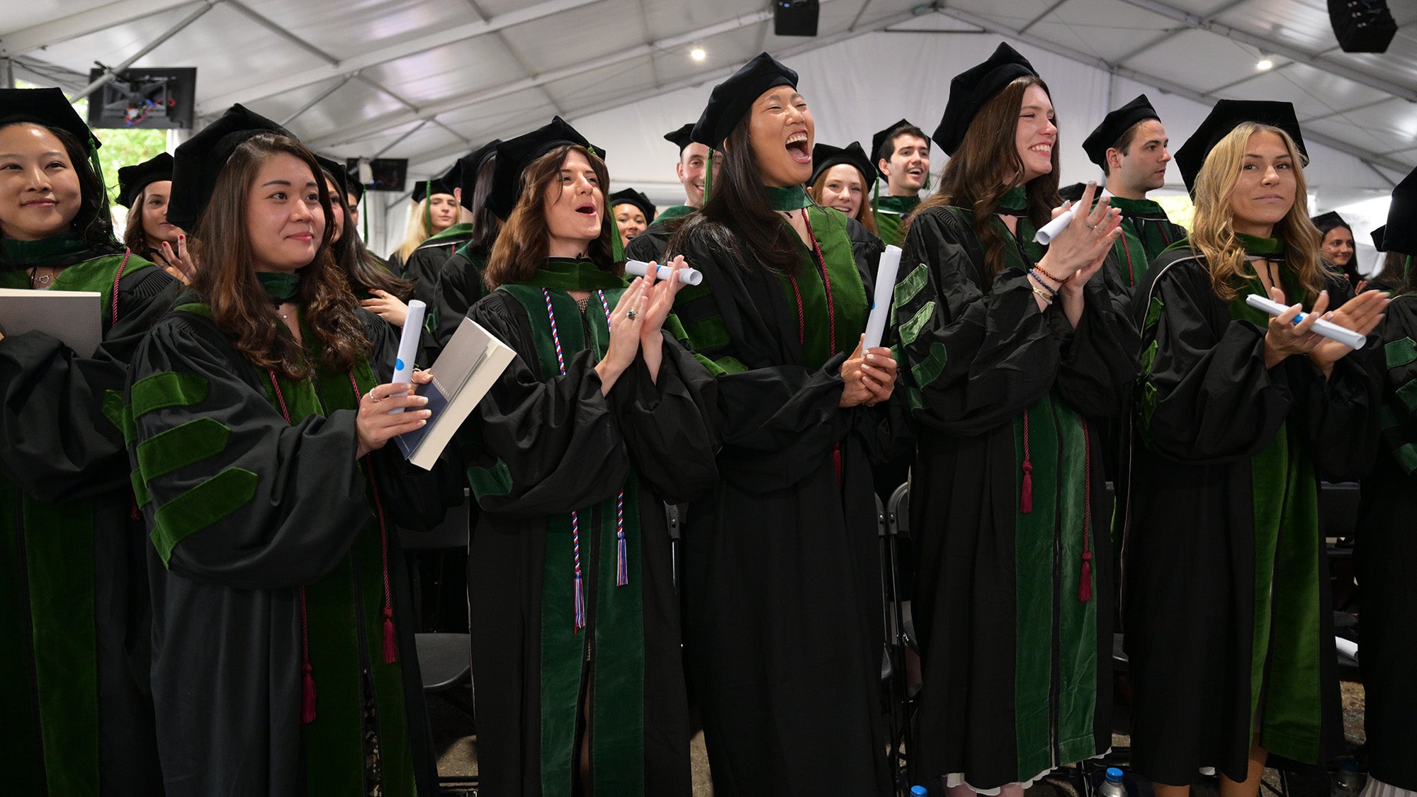 Students celebrate their commencement with smiles and cheers