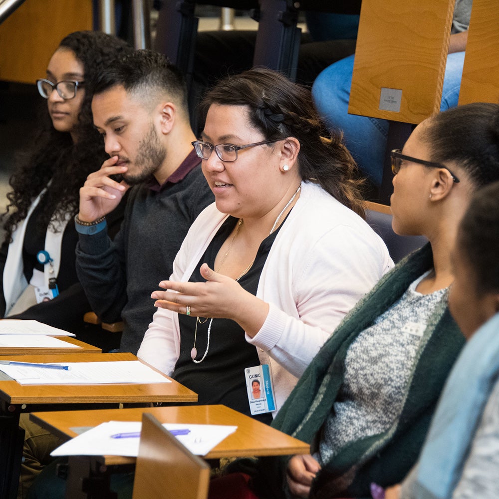GEMS students sit in Proctor Harvey and discuss a topic