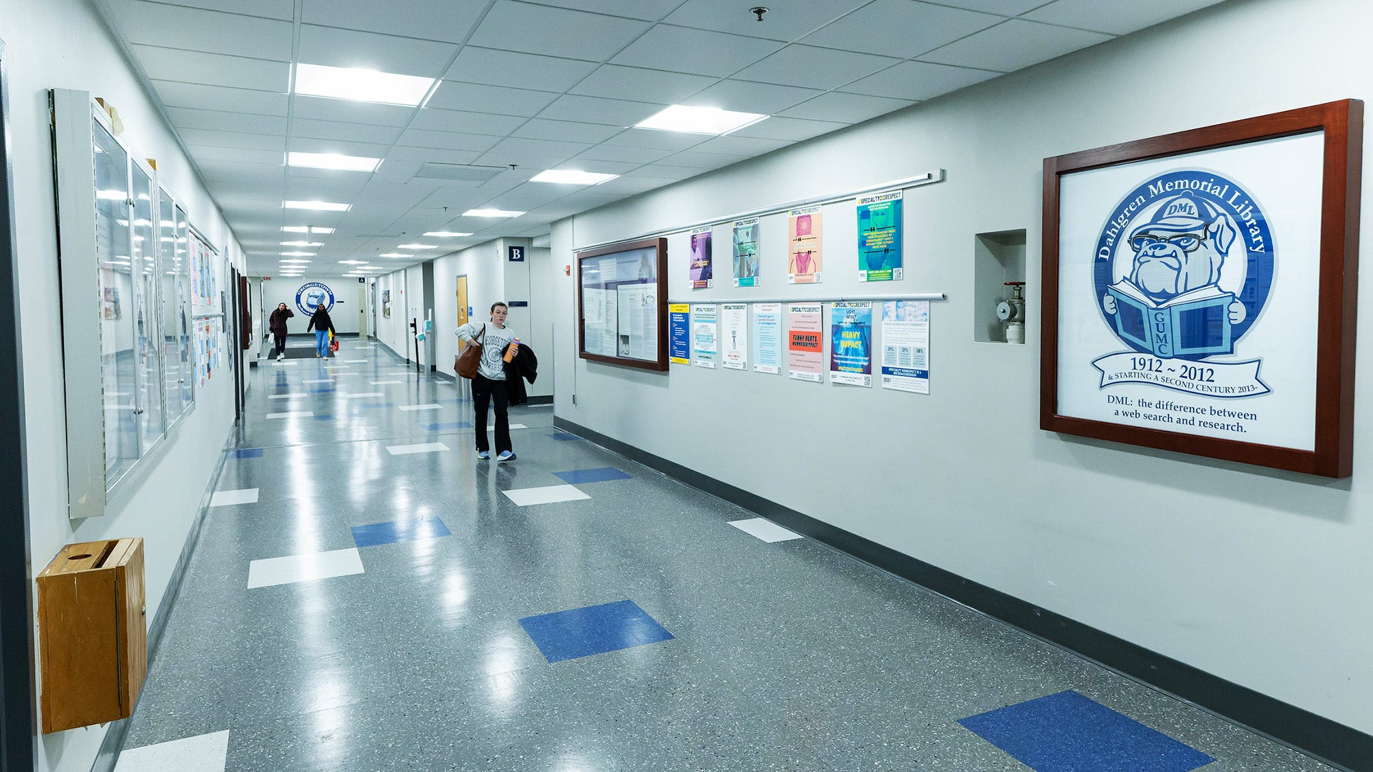 Student walking down a hallway outside the library