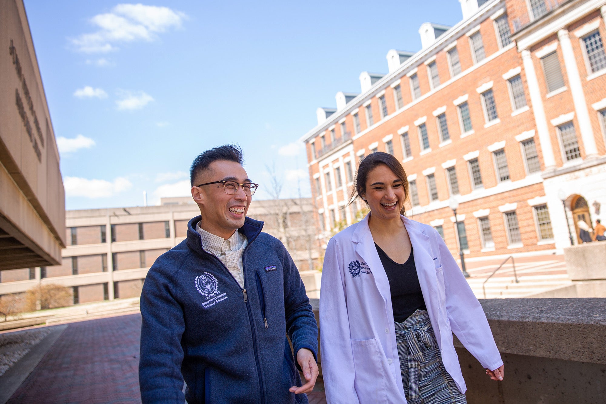 Two students walk near the Med-Dent Building