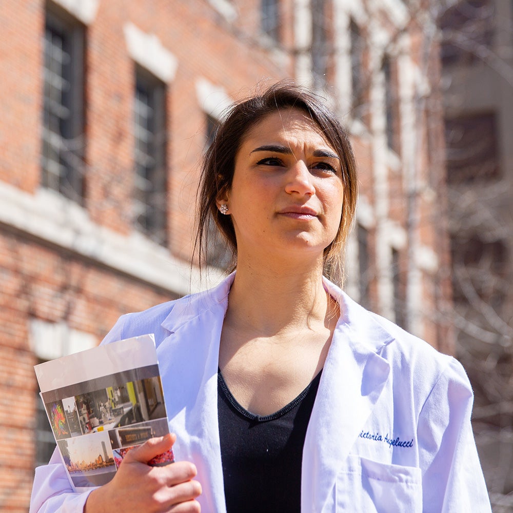 A med student walks near the Med-Dent building