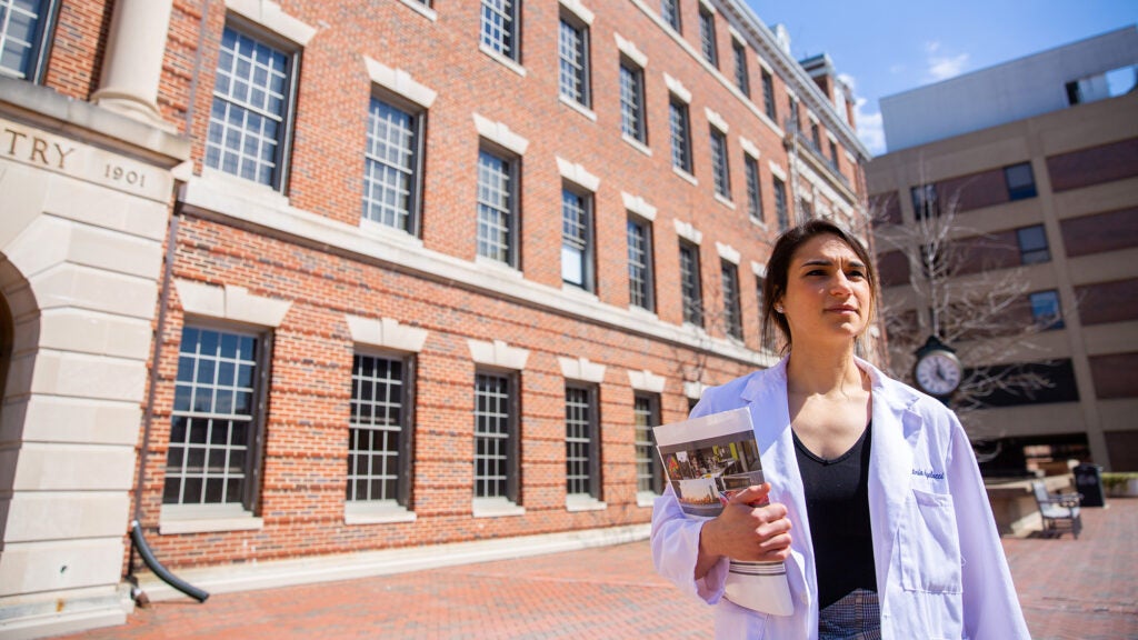 A med student walks near the Med-Dent building