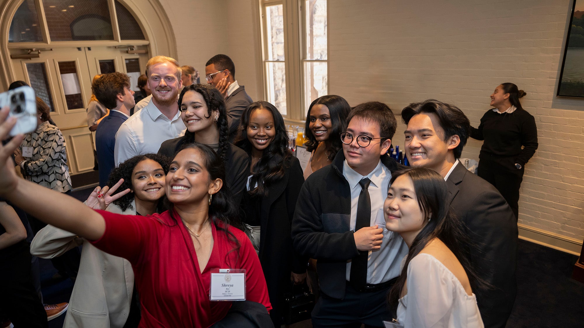 Med students stand together to take a group selfie at an event they are attending