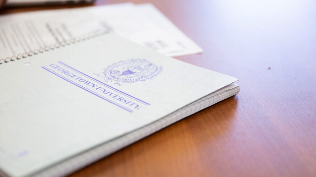 Closeup of two notebooks with Georgetown name and seal on the cover