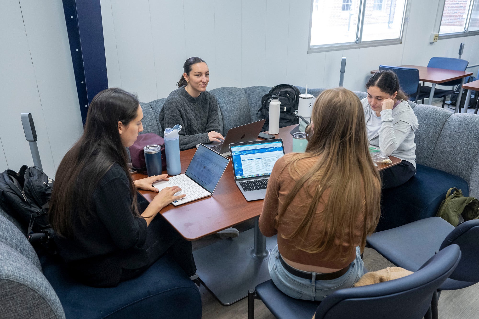 A group of four students studies in the Med-Dent Annex study room
