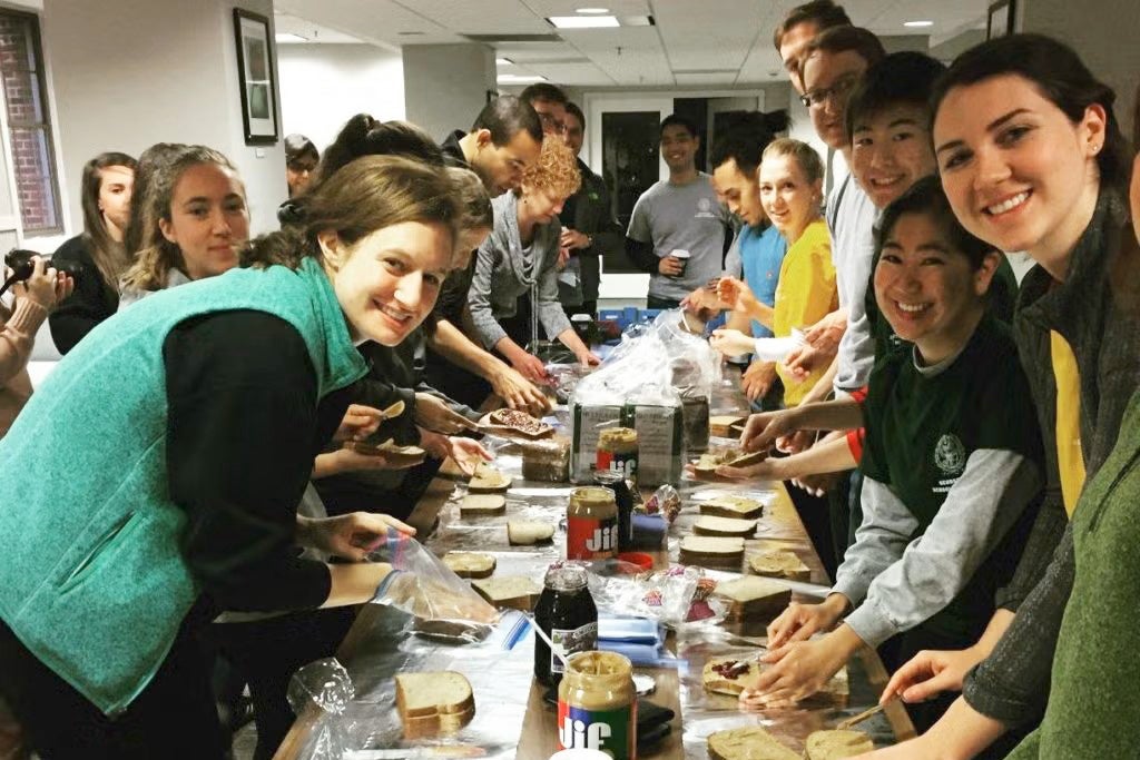 Medical students make peanut butter sandwiches in quantity as a service project