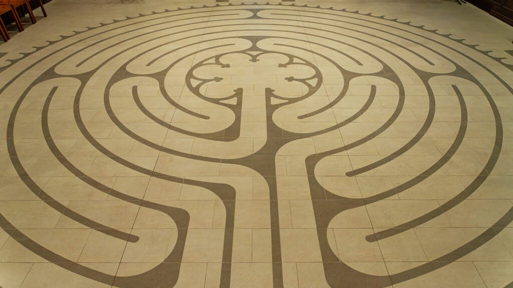 A labyrinth for meditative walking is embedded in the floor of a chapel