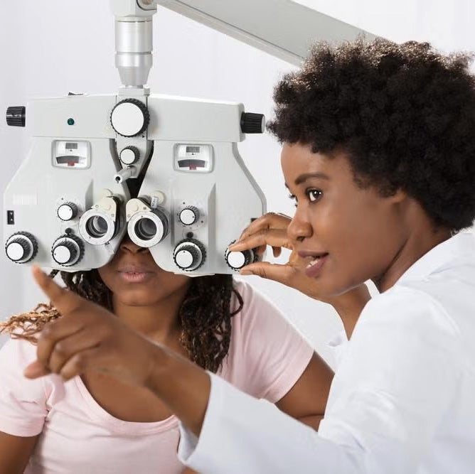 An ophthalmology assistant administers a vision test to a patient