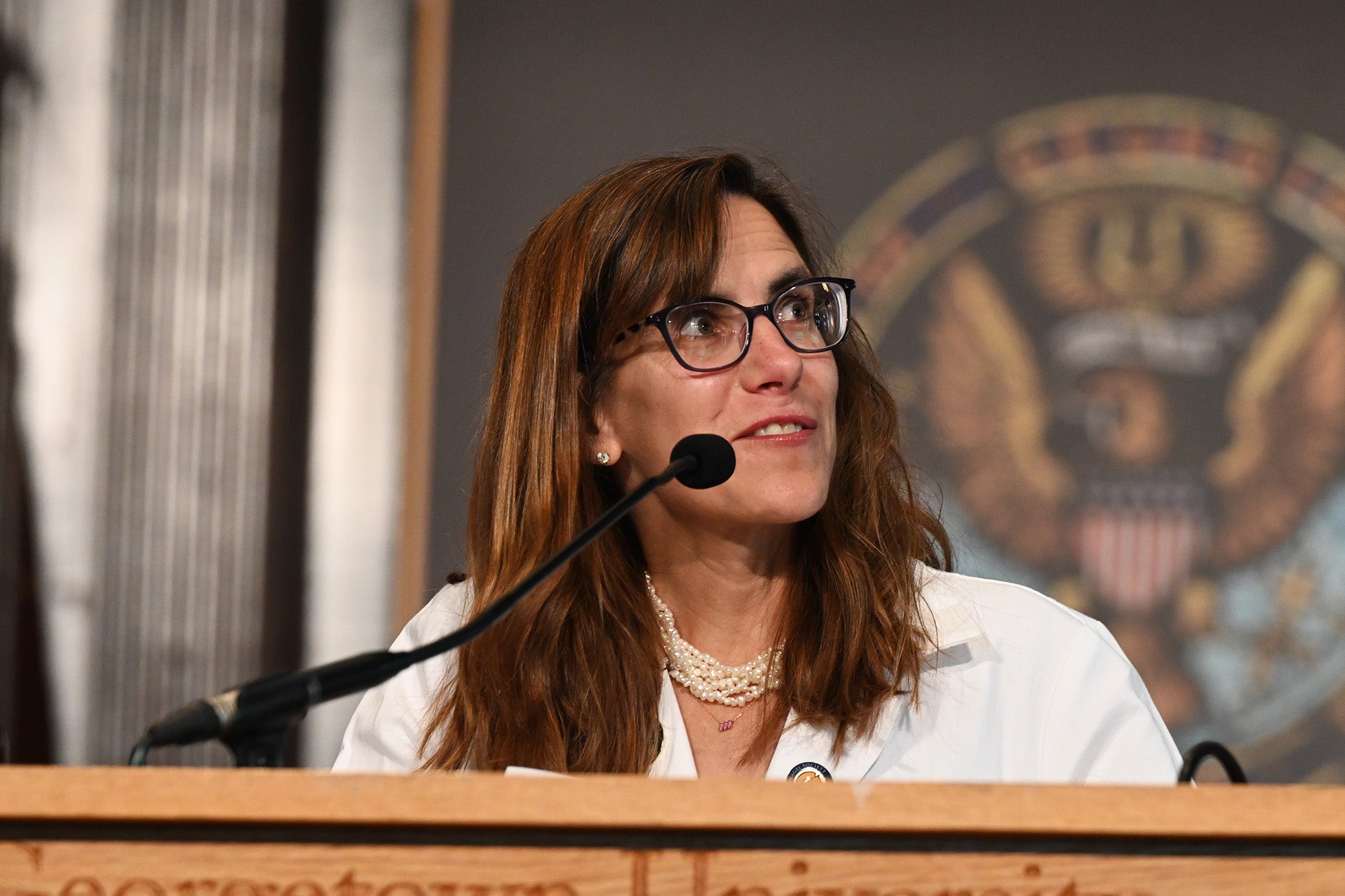 Dean Mary Furlong speaks from a podium