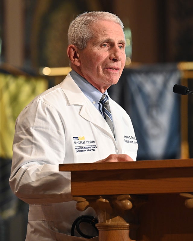 Dr. Fauci speaks from a podium