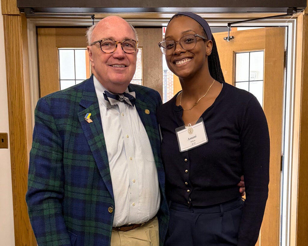 Dr. Mitchell and Amani Wilson stand together in a hallway at the School of Medicine