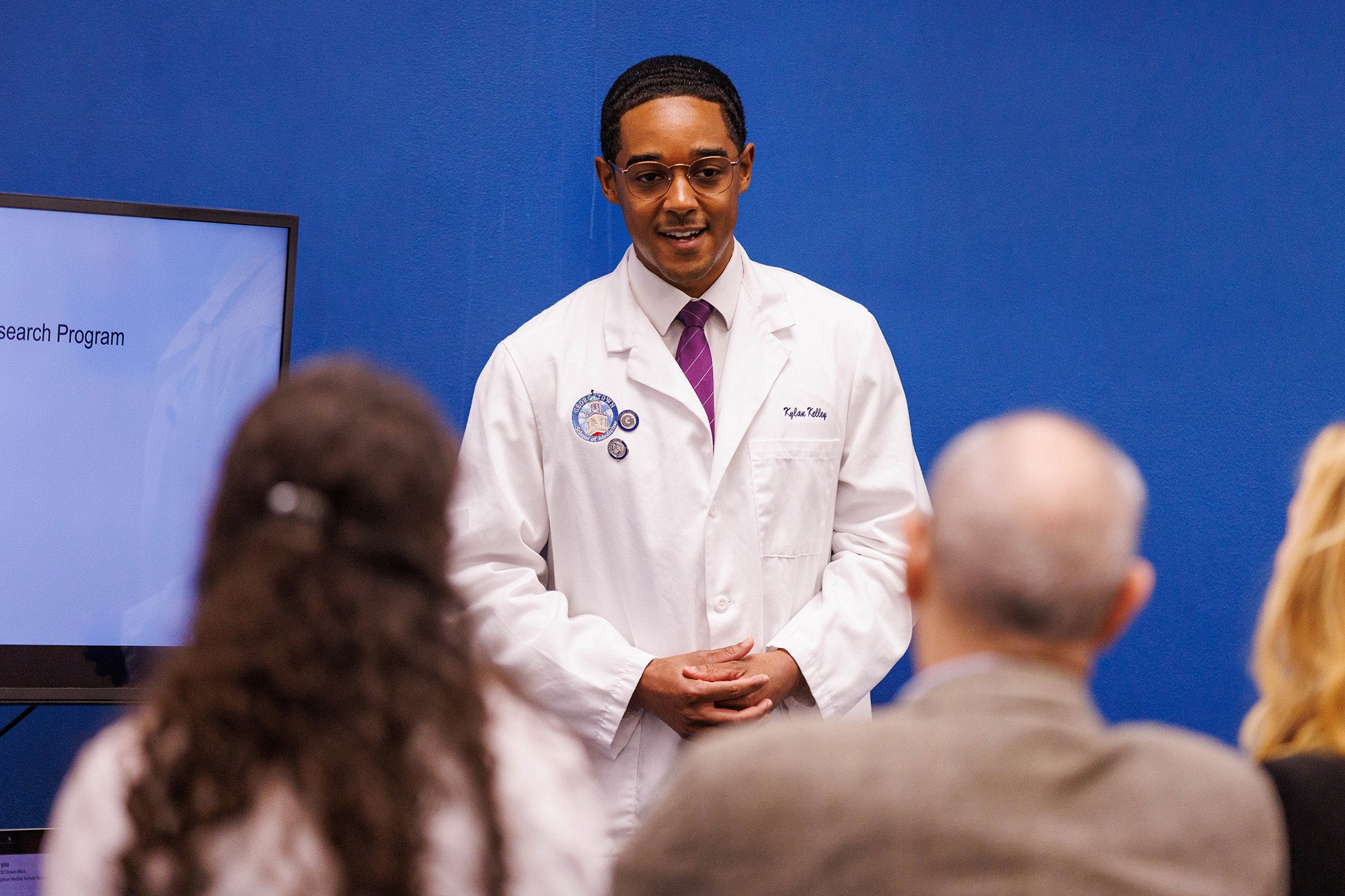 A medical student speaks before an audience