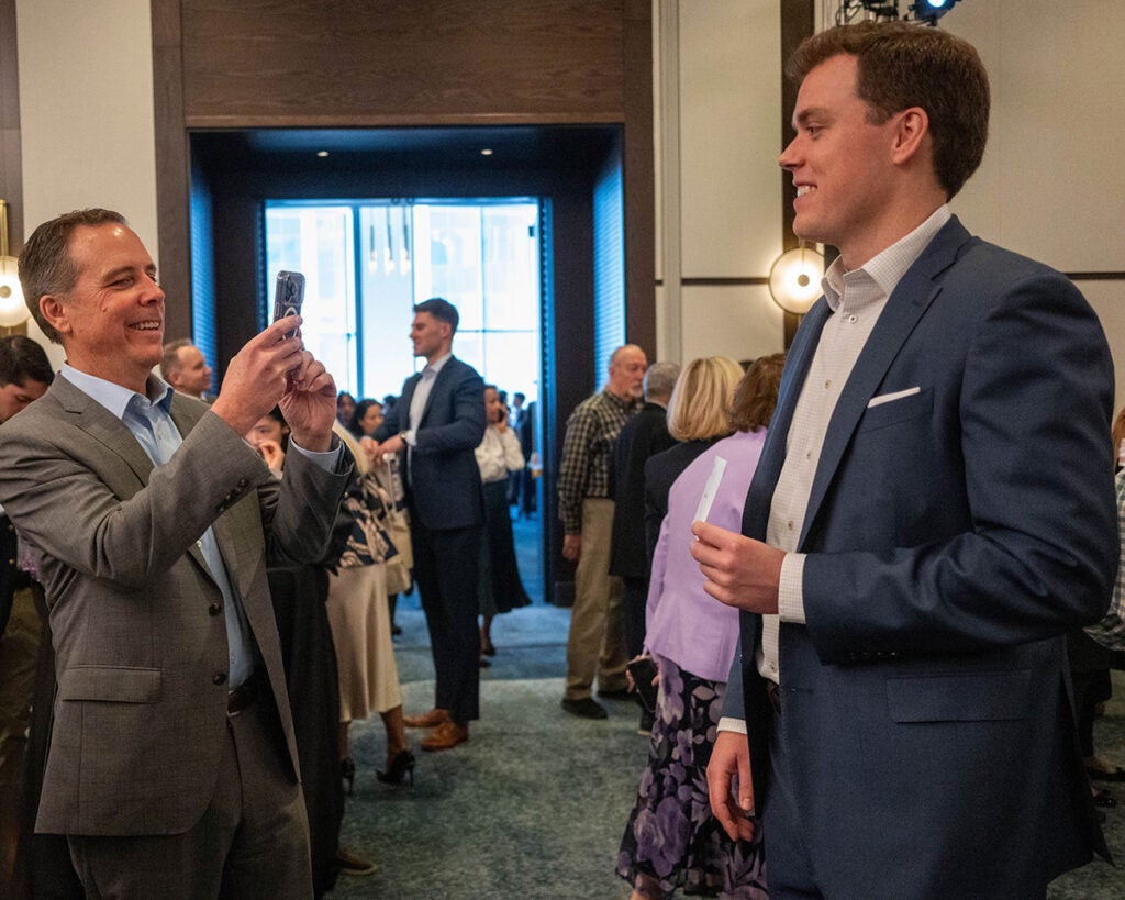 Michael Covell poses for a photo with his unopened match envelope