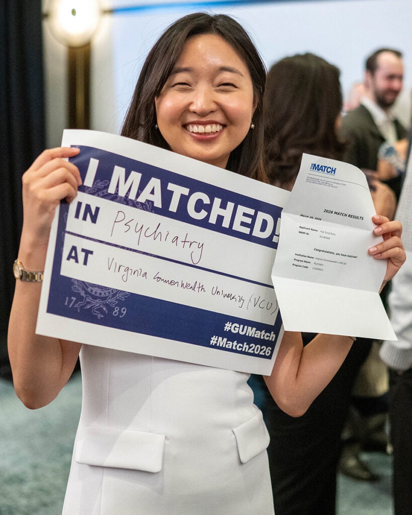 Hye Sung Sanding holds her Match Day sign and letter