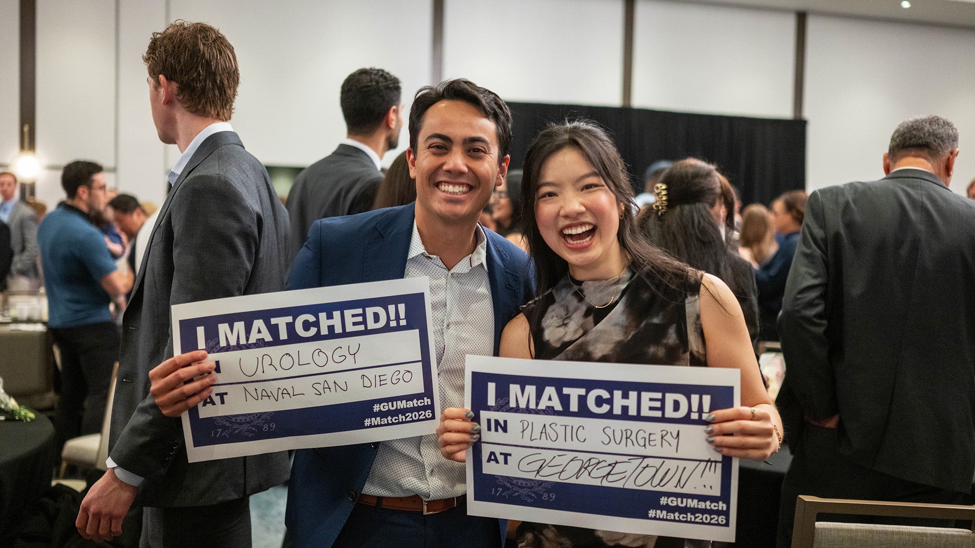 Two students hold Match Day signs