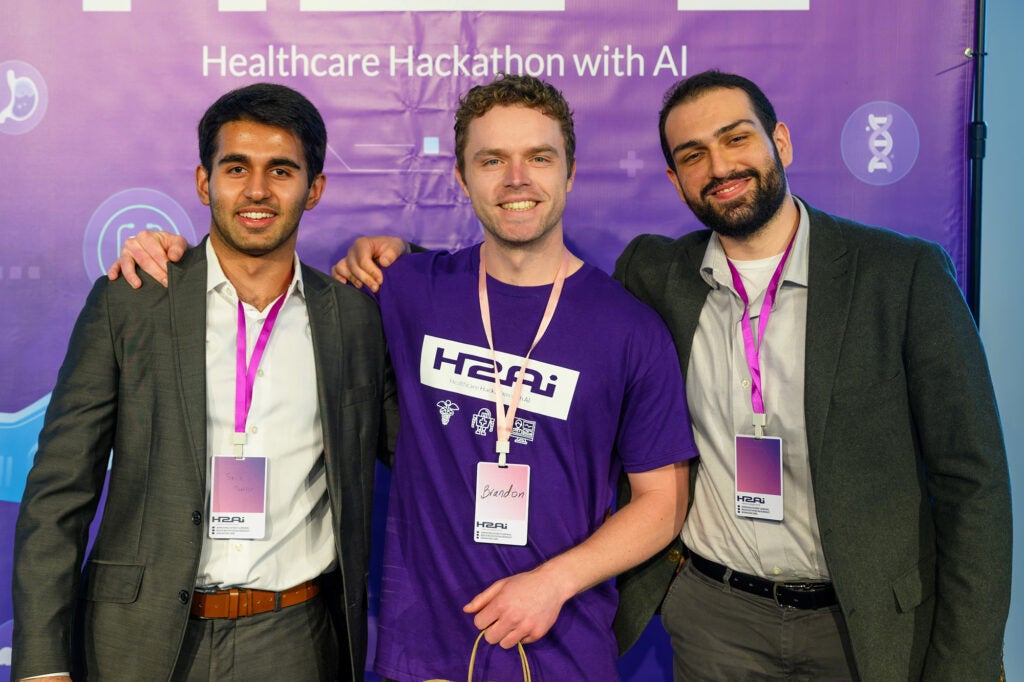 Three individuals stand together