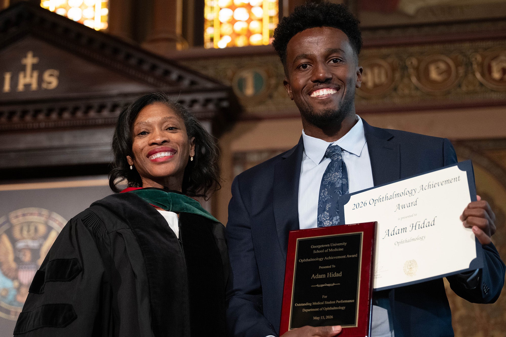 Dr. Oboh-Weilke stands next to Adam Hidad who is holding his awards