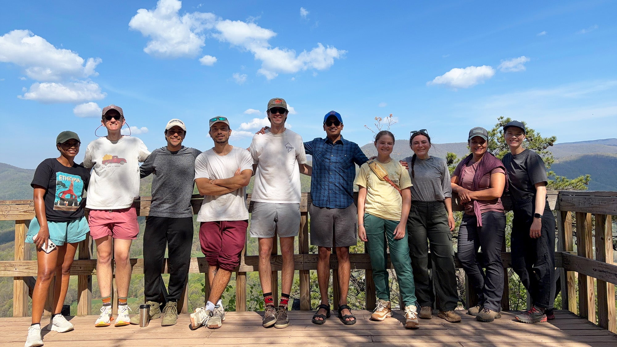 Ten individuals from the Wilderness Medicine course stand together at a scenic overlook in West Virginia