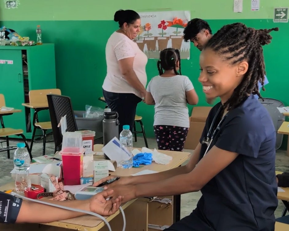 Katrina Hodges takes a patient's blood pressure