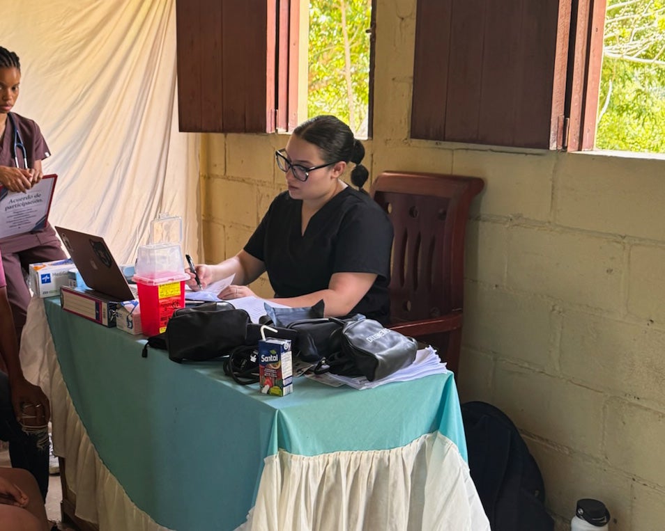 Halyn Orrellana taks a medical history from a patient