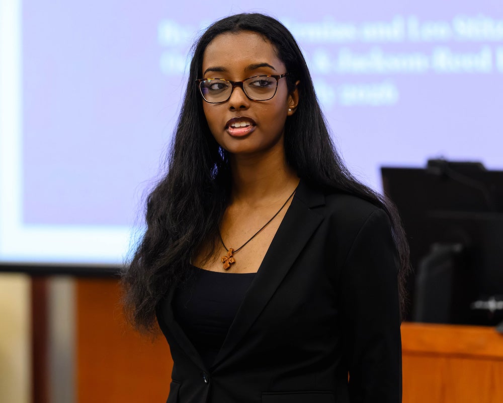 Adonia Ermias speaks before an audience