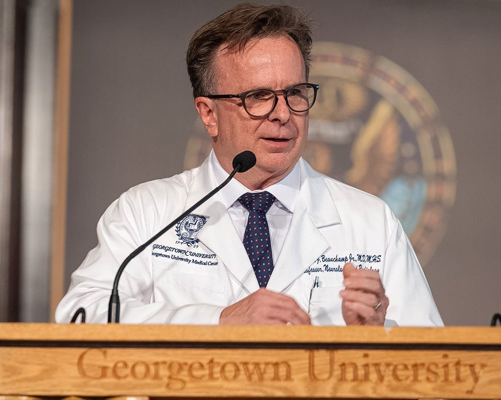 Dr. Beauchamp speaks from a podium