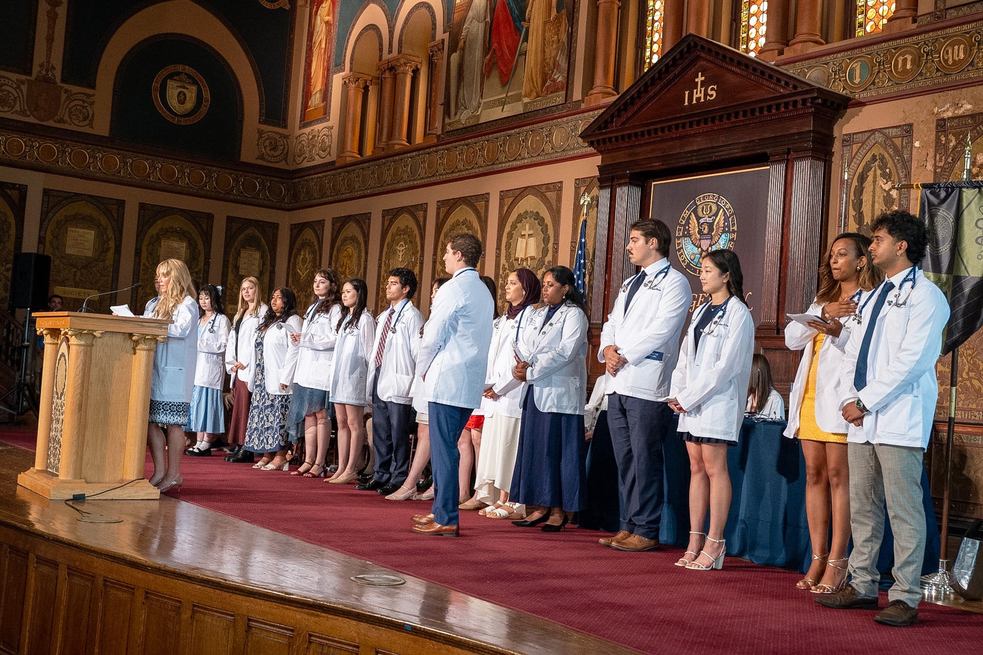 Students stand in line awaiting their turn to speak at the podium onstage in Gaston Hall