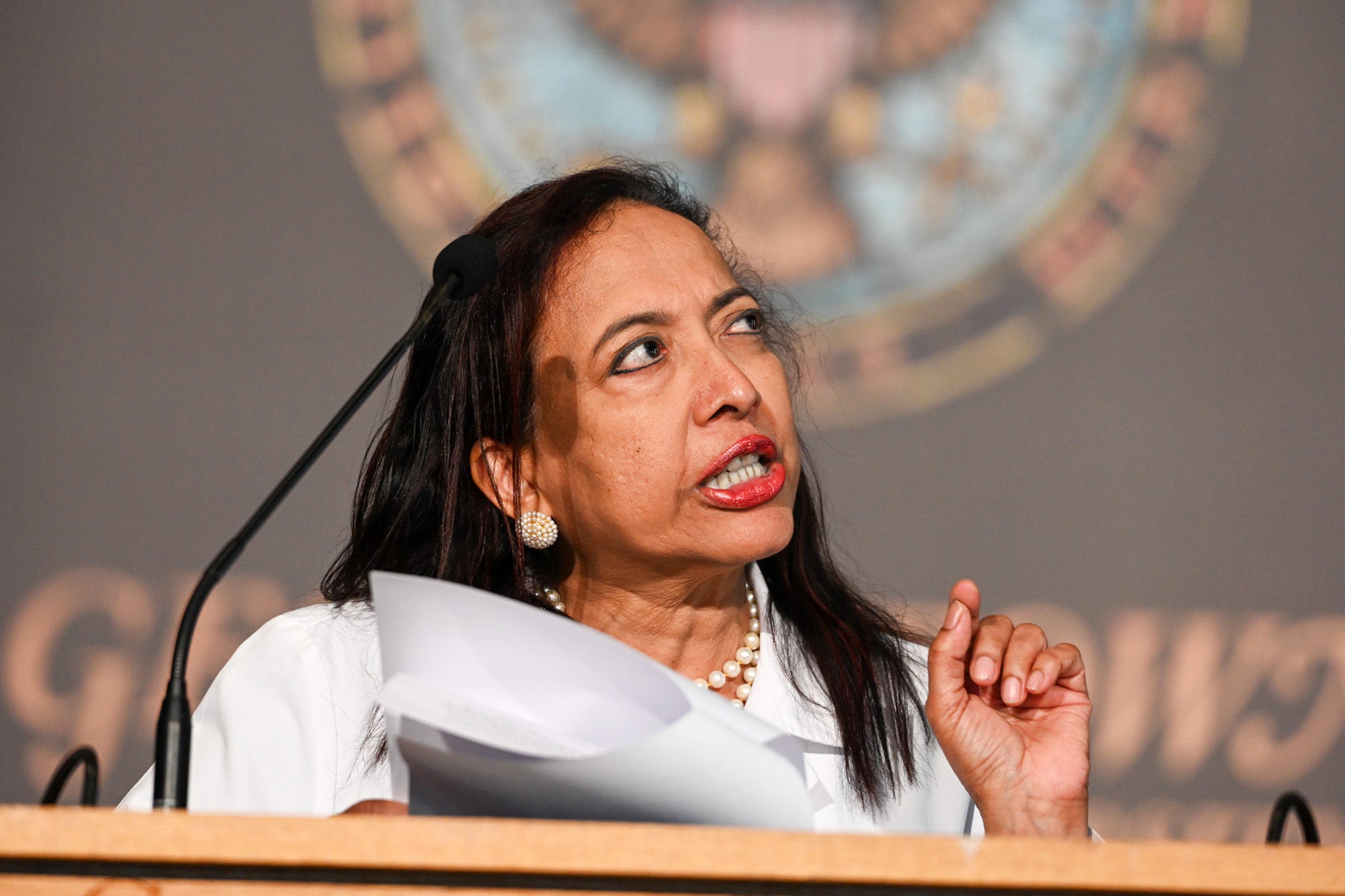 Dr. Princy Kumar speaks from a podium in Gaston Hall